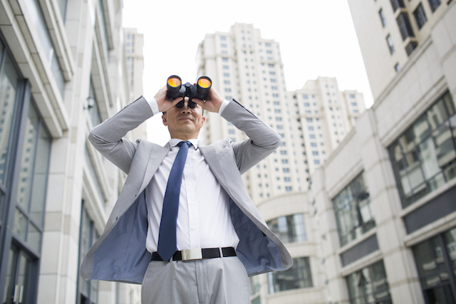 businessman-looking-through-binoculars-representing-market-approach-business-valuation-FEATURE