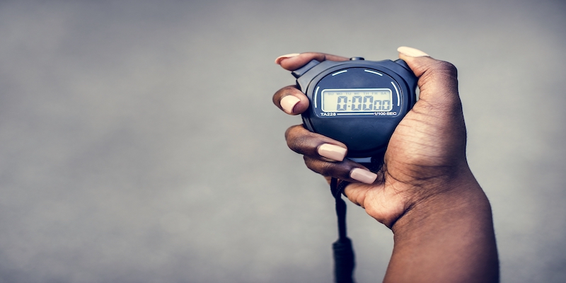 hand-holding-stopwatch-how-long-before-debts-are-written-off