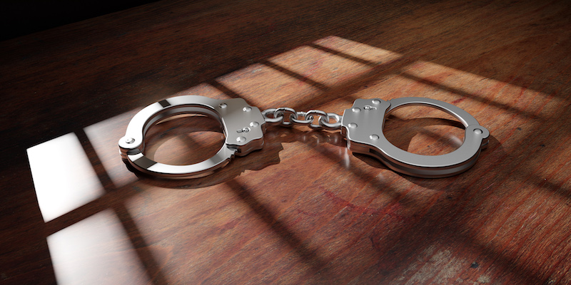 jail-bar-shadow-and-handcuff
