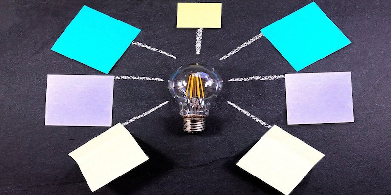 lightbulb and post it notes to signify ideas