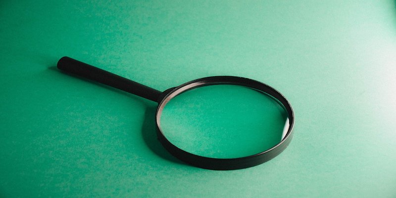 magnifying glass on green table