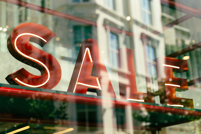 sale-sign-in-shop-window-with-reflections