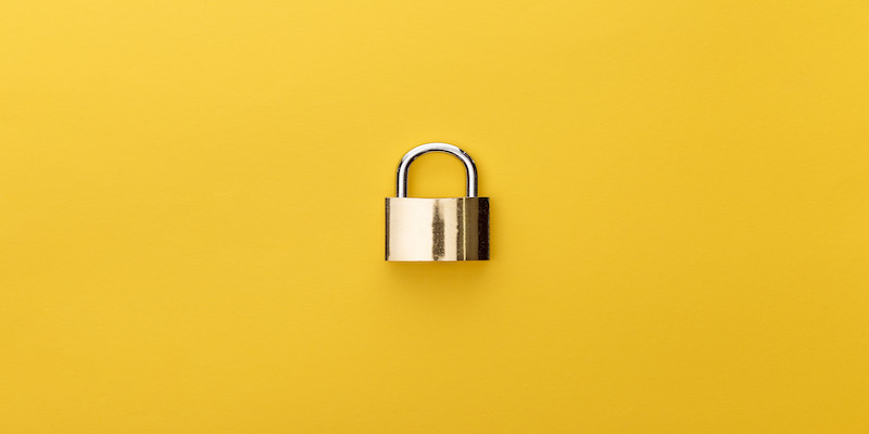 top-view-of-metal-padlock-on-yellow-background